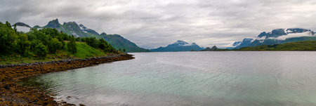 Panorama of the sea and high mountains in the fjord in Norway. Wild nature in the north of Europe in...