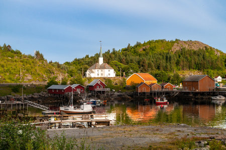 A small village with colorful wooden houses and a white wooden church on the sea coast in Norway, Northern Europe.の写真素材