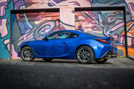 Brno, Czech Republic - October 28, 2023: A fast small Subaru BRZ sports car is parked on the road in front of a colorful painted wall.のeditorial素材