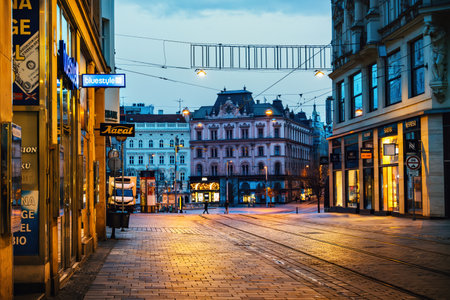 Brno, Czech Republic - March 18, 2024: Empty street in the city in the early morning lit by shop windows. Historic city center in Europe.のeditorial素材