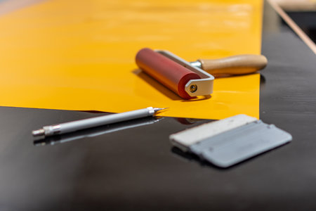 Workbench with tools for the production of foil advertising stickers.の写真素材