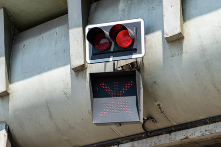 Red warning lights at the entrance to the tunnel mounted on a concrete pillar. Signaling for traffic control in a tunnel in the city.の写真素材