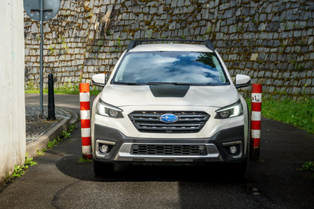 Stadlec, Czech Republic - June 12, 2025: A Subaru Outback SUV drives through a narrow passage between two pillars. Passage to the Sladlec Bridge in South Bohemia.のeditorial素材