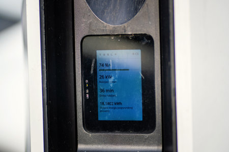 Brno, Czech Republic - December 31, 2025: A close-up of the display of a Tesla charging station while an electric car is charging. The display shows the status, power and chargingのeditorial素材