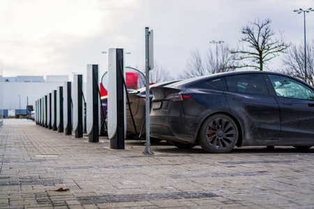 Brno, Czech Republic - December 31, 2025: Row of charging stations for Tesla electric cars. Charging cars outdoors on the street.のeditorial素材