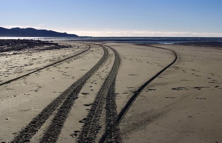 tyre tracks left by off road motorcycles make interesting pattern in the beach sands at Waikanae Beachの写真素材