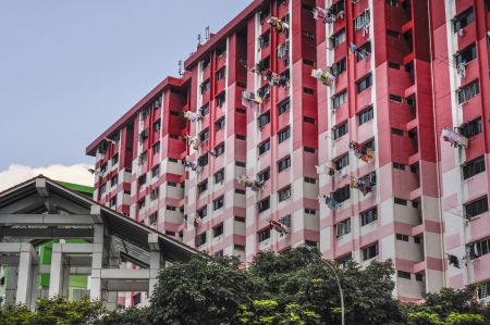 Apartment Blocks in Singapore showing high rise concrete buildings with a red colour schemes ...
