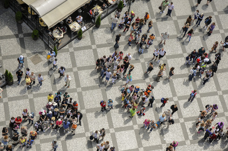 Birds eyevew - Groups of people gather together around a guide as other people mill around ...
