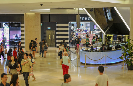 the interior of a busy modern shopping in Singaporeのeditorial素材