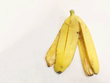 Yellow banana peel on white background isolatedの素材