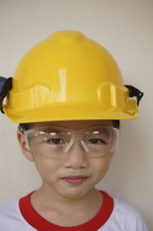 Young Asian boy on hard hatの写真素材