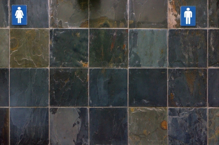 Gender signs on a tiled wallの写真素材