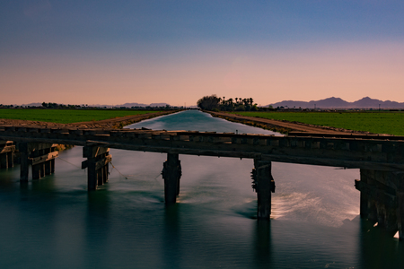 a canal, a railroad track. while one lays in ruins. the other is striving for greatness.の写真素材