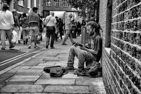 Street musician playing the guitar in Brick Lane, London