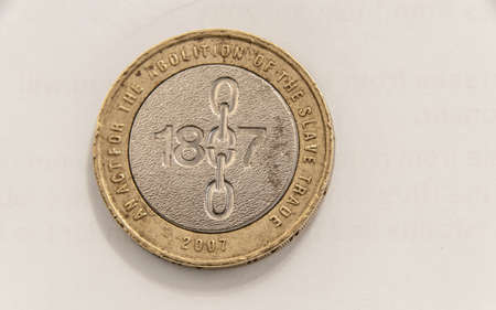 London, United Kingdom, November 30, 2020: Two Pounds Great Britain coin including scrapes, scuffs, blemishes, and imperfections from the weathered 2007 coin.Coin 1807 Slavery Reverseのeditorial素材