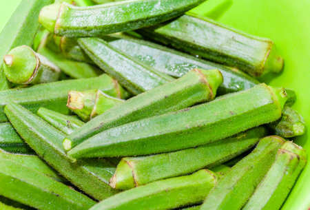 London, United Kingdom, January 04, 2021: Fresh Ochra, Bhindi or Ladies Fingers whole and uncooked against a white background for cut outの写真素材