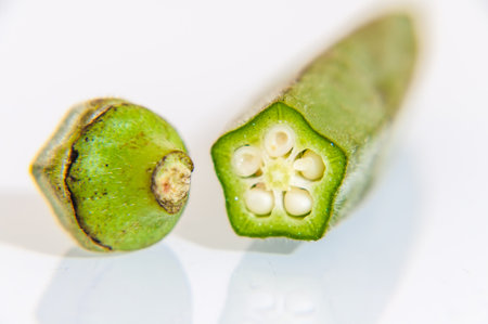 London, United Kingdom, January 04, 2021: Fresh Ochra, Bhindi or Ladies Fingers whole and uncooked against a white background for cut outの写真素材