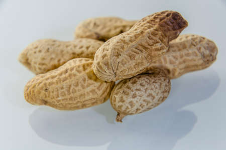 London, United Kingdom, December 05, 2020: Peanuts aka groundnuts on board in shells