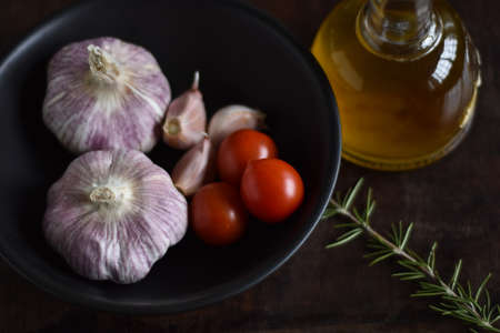 Salt, olive oil and garlic on wooden backgroundの写真素材