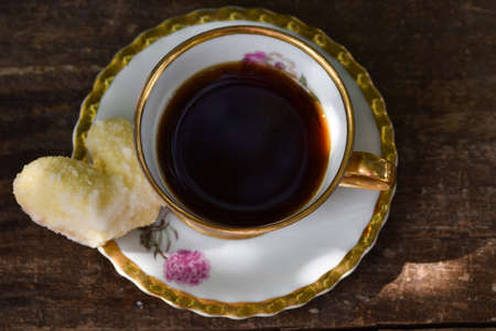 old cup and homemade cookies on rustic backgroundの写真素材