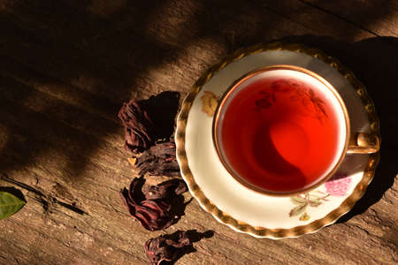 antique and delicate cup with hibiscus tea on rustic backgroundの写真素材