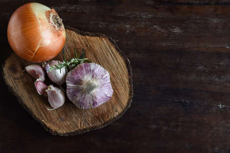 Top view of organic ingredients: garlic, rosemary and olive oil. On rustic wooden table. With space for textの写真素材