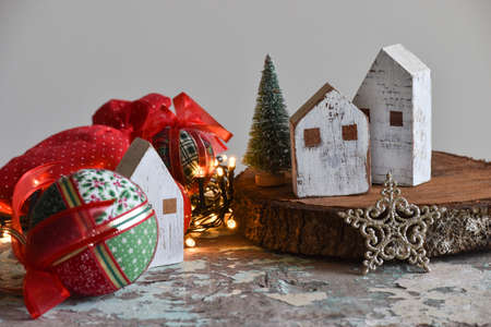 Christmas decoration: handmade fabric balls, stars, toys and light on rustic table with gray backgroundの写真素材