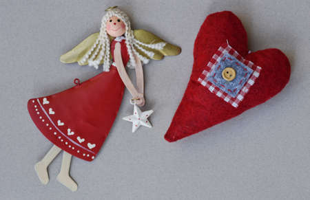 Christmas decoration: handmade fabric balls, stars, toys and light on rustic table with gray...