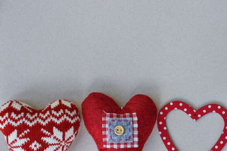 Christmas decoration: handmade fabric balls, stars, toys and light on rustic table with gray...