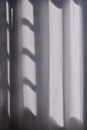 white curtain in front of window in sunny dayの写真素材
