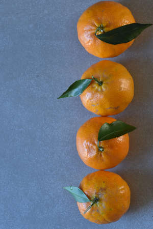 fresh tangerines on gray background. selective focus. Top view. Copy space