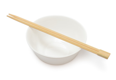 Empty bowl with chopsticks isolated on white backgroundの写真素材