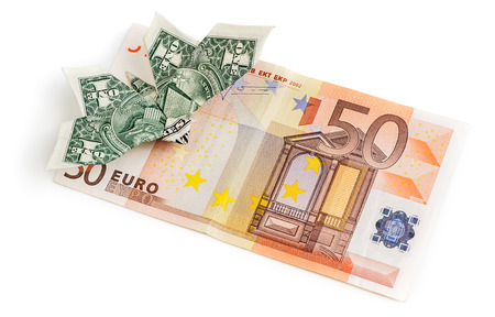 Dollar origami butterfly sits on 50 euro banknote isolated on white background. Concept of two leading hard currencies - US Dollar versus Euroの写真素材