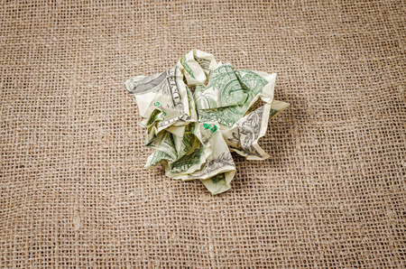 US dollar banknotes crumpled on rustic jute backgroundの写真素材
