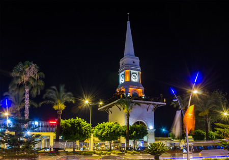 Illuminated central clock tower in Kemer, Turkey. Kemer a seaside resort on the Mediterranean coast of Turkey, Antalya Province. Night view.の写真素材