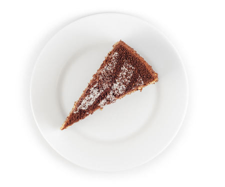 Piece of chocolate cake in plate isolated on white background. Top view.の写真素材