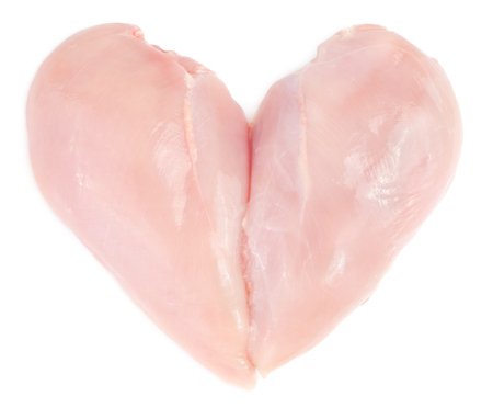 Raw chicken breast fillet in heart form isolated on white background.の写真素材