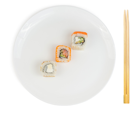 Sushi rolls in plate with chopsticks isolated on white backgroundの写真素材