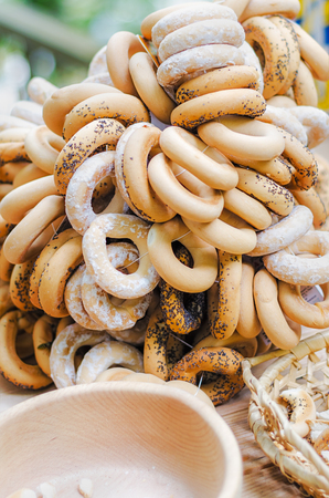 Drying bread bagels with poppy seeds. Selective focus. Bundle of bagels are sold at the fair-sale.の写真素材