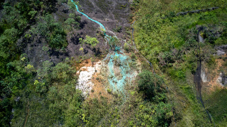 Copper stained water stream in open pit mine.の写真素材
