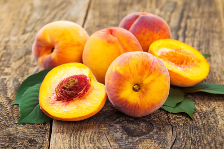 group of fresh peaches on wood backgroundの写真素材