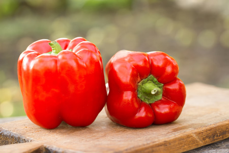 Fresh red pepper on wooden table on nature backgroundの写真素材