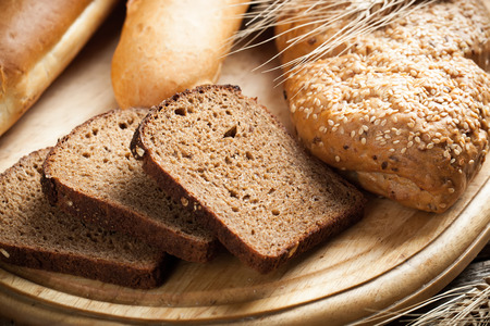 assortment of baked bread on wood table