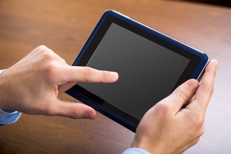 Businessman using tablet by the desk