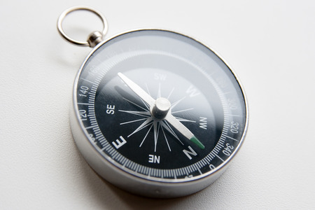 black compass on a white background in perspective with flare