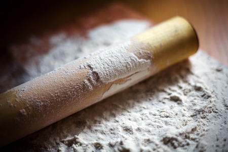 flour with a rolling pin on a cutting board. soft focusの写真素材