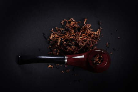 pipe and tobacco on a black backgroundの写真素材