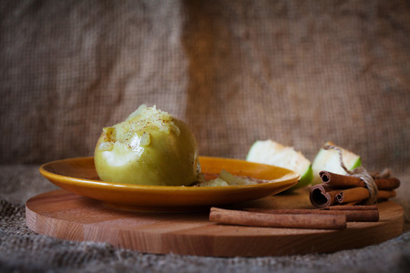 baked apple with cinnamon on a plate, soft focusの写真素材