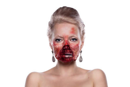 Portrait of blond bloody zombies in a festive makeup, isolated on white backgroundの写真素材