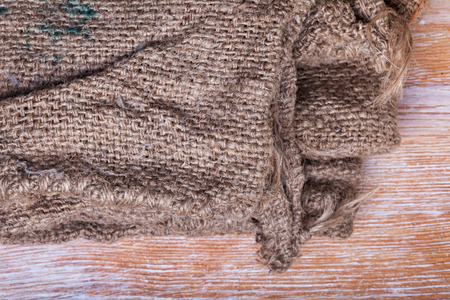 texture of the old rough jute bag with signs on wooden backdroundの写真素材